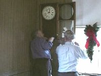 oe Veneziano and Larry Grubb hanging Joe's wall clock.