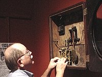 Chapter 124 President Bill Edwards does some fine tuning on this clock before putting the dial and hands back on it.