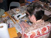 Pat Holloway removing paper to start a transfer painting.