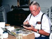 Longtime Chapter 80 and Chapter 124 member Bill Pickett touches up his painting.