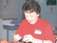 Frann Michael is trying not to laugh and blow her gold off the glass.