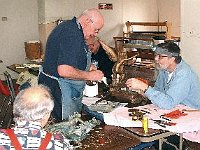 Instructor Dick Michael goes over some points with Paul Rabe. Joe Veneziano looks on.