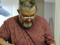 Instructor James Spivey demonstrates the use of a small power sander.