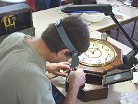 Ray Gearhard is repairing rosewood veneer on his clock.