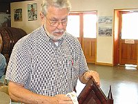 John Lewandowski wipes his clock after restoration.