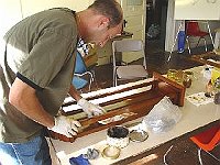 Mixing shellac and a metallic dye to make a toner proved to be the key to help Steve Skrasek put the midas touch on this Vienna regulator. Here, Steve is polishing the case with 0000 steel wool and a pigmented paste wax to give the shellac finish a uniform satin sheen. Wow!