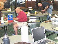 Len Kaufman (front), Joe Giles (back) working on veneer repair.