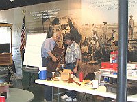 Wooden Case Clock Restoration II.  Gary Mowery getting a consultation from instructor Craig Burgess on how to repair a veneer.