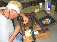 John Sparks trying to match grain for veneer repair.