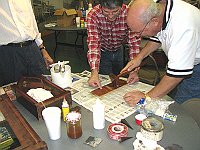 Craig Burgess instructing Len Kaufman on veneer repair using veneer hammer.