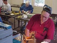 Jimmy Busby uses a beat amplifier in checking out his clock.