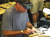 John Acker is finishing sanding a part he just made.