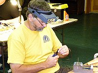 Stan Wallace is shaping an arm on the lifting lever he is making.