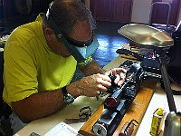 Bruce Wooldridge is installing a tool in the tool holder on his lathe.