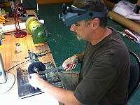 John Acker is filing the square on a winding arbor.