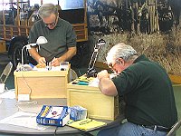 Tom Gavin and Jim Redmon are working on their pocket watches.