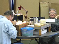 John Acker and Fred Tishler.  Fred must have fixed his watch (or maybe he just found his watch jewel screws!)