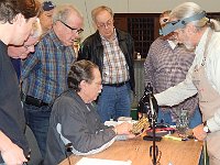 Mark points out features of Mel's kitchen clock movement to the class.