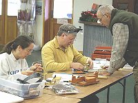 Ross Mancuso  helps Dave Lippe while Julia Kuhn works on her movement.