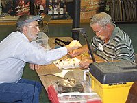 Joe Richards helps Darren Barber sort his wheels.