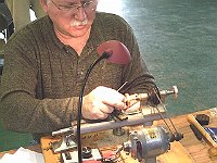 David Lippe is checking his brass sanding wheel screw thread depth.