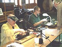 Kelsey Downum and Sam Creech busy trying to finish their project while Hugh Slough is monitoring their progress.