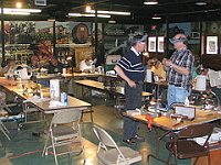 This photo shows the whole class is busy working on their projects on the jewelers lathe.  Jeff Waguespack is getting some clarification from instructor Russ.