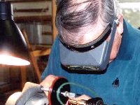 Cutting an arbor for a grinding wheel.