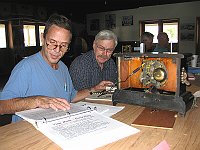 Alex and E.K. use a Microset to check the timing and beat on a clock movement.