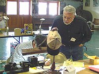 John Lewandowsky looks on as Bill Andrle performs his magic on the lathe.