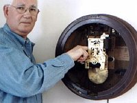 Jim Schonaerts explains how the pendulum on his clock needs more clearance to run correctly. 	 Photo Jim Schonaerts