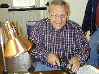 Ron Oorlog is cutting a brass plug to be soldered in a spring barrel.