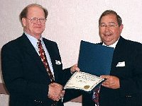 Incoming President Russ Aikins presents the outgoing President Claude Leis with a lifetime membership certificate in Chapter 124 as a special "Thank You" for a job well done during the past year.