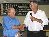 New president Bill Andrle presents outgoing president Bill Edwards with a little gift of appreciation for a job well done.