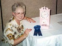 Wilma Cothren's clock is "Cross Stitching". The 12 inch tall Mary Kay Pink clock has a Pink Cadillac shown in the center. The dream of every Mary Kay consultant!! Wilma received a first place in Novelty Class.