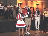 NAWCC Nationals are FUN! In addition to all the educational presentations, exhibits and marts, there is always entertainment. Here Chapter 124 member Phil Ball dances at the Pig Pickin' with one of the featured "Cloggers".