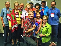 Some of the Chapter 124 members at the National assemble in front of the display for a photo op!