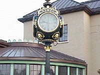 Chapter 124 members Fred Tischler, NAWCC President George Orr, and David Tips in front of the street clock outside the new NAWCC museum.