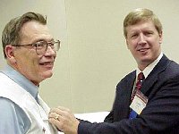 At the luncheon, Gerry Friedman announced that Gene Meysenburg had been appointed an NAWCC Fellow. Here Jimmy Young presents Gene with the official Fellow pin.