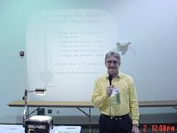 Fred Tischler giving a presentation on how to compute the length of a pendulum in order to make a clock keep good time.